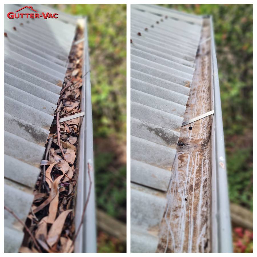 Close view of a gutter filled with leaves and twigs, then cleared to the base